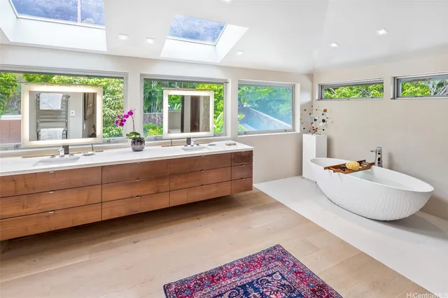 a bathroom with a tub sink and mirror