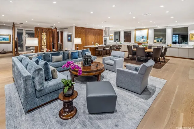 a living room with furniture kitchen view and a chandelier