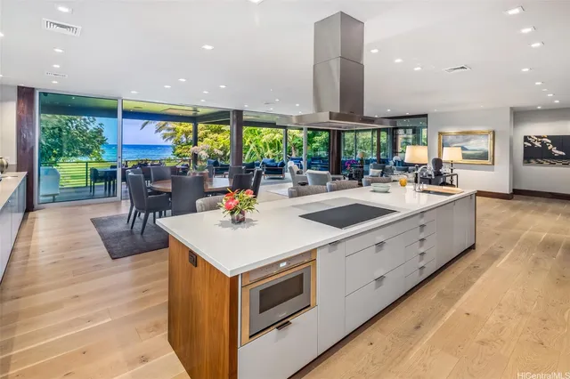 a large kitchen with stainless steel appliances a large window and a counter top space