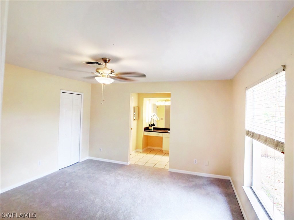 17424 Delaware Road Fort Myers, FL 33967 - Photo 6 of 12 a view of a livingroom with a chandelier fan and windows