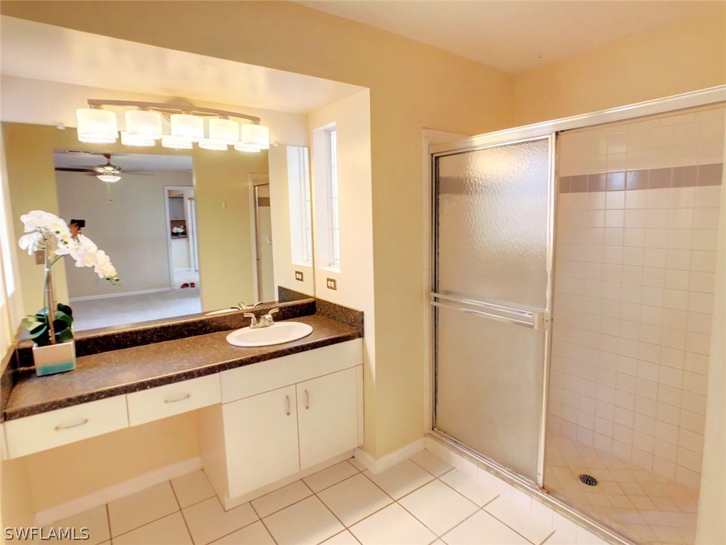 17424 Delaware Road Fort Myers, FL 33967 - Photo 8 of 12 a bathroom with a double vanity sink and a mirror