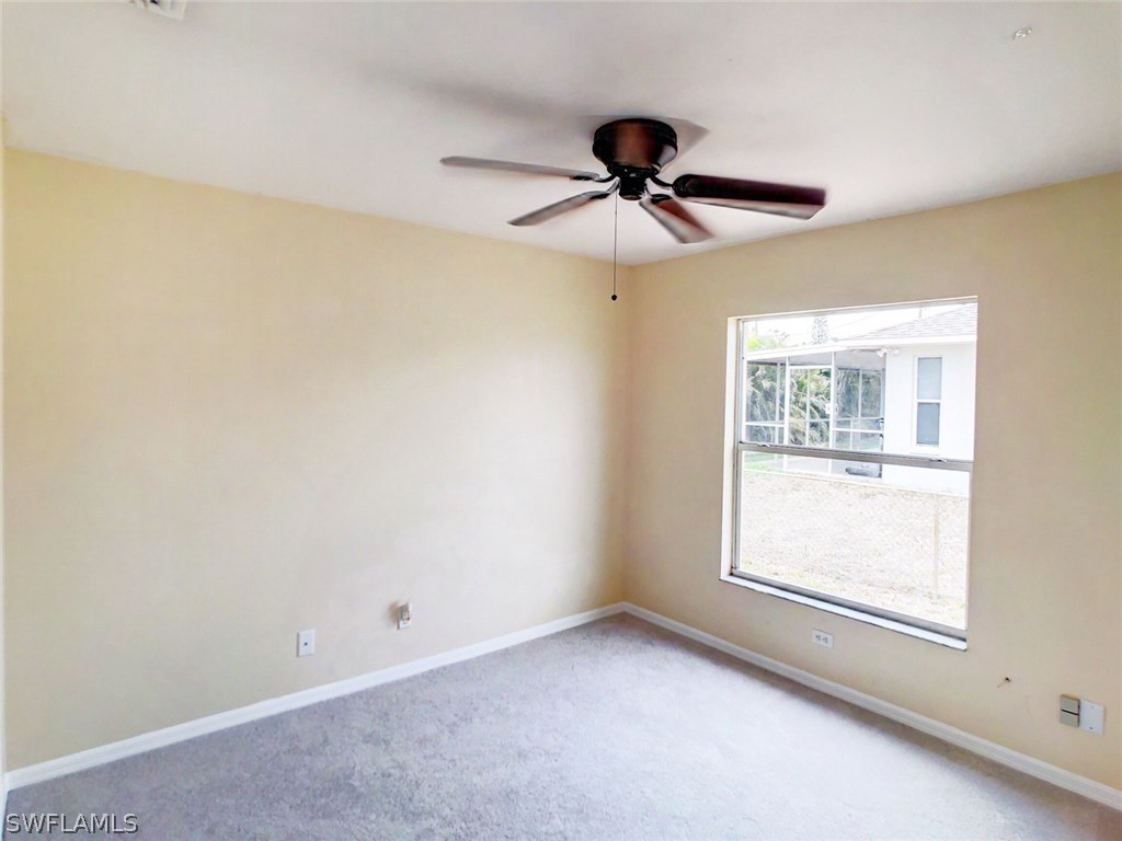 17424 Delaware Road Fort Myers, FL 33967 - Photo 9 of 12 a view of an empty room with a window