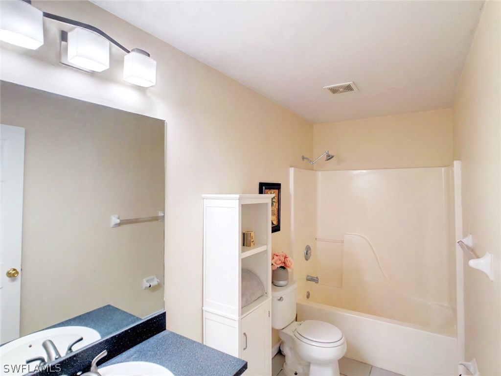 17424 Delaware Road Fort Myers, FL 33967 - Photo 10 of 12 a bathroom with a toilet a sink and a shower