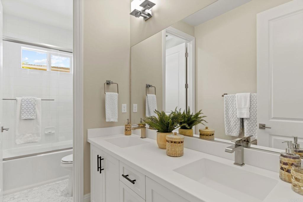 663 Polaris Drive Encinitas, CA 92024 - Photo 24 of 34 a bathroom with a granite countertop sink and a mirror