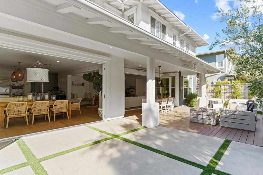 663 Polaris Drive Encinitas, CA 92024 - Photo 32 of 34 a view of a patio with table and chairs potted plants and floor to ceiling window