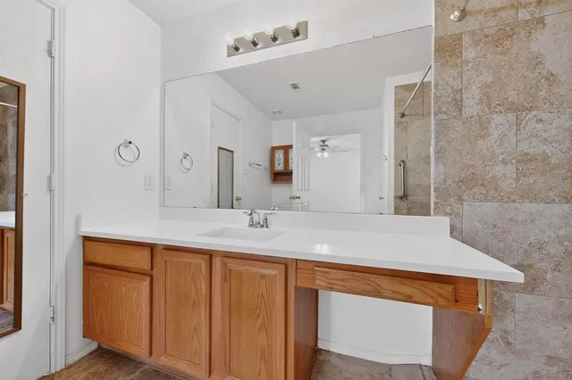 a bathroom with a sink and mirror