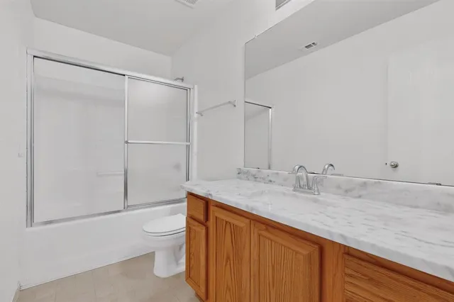 a kitchen with stainless steel appliances granite countertop a refrigerator a stove and a sink