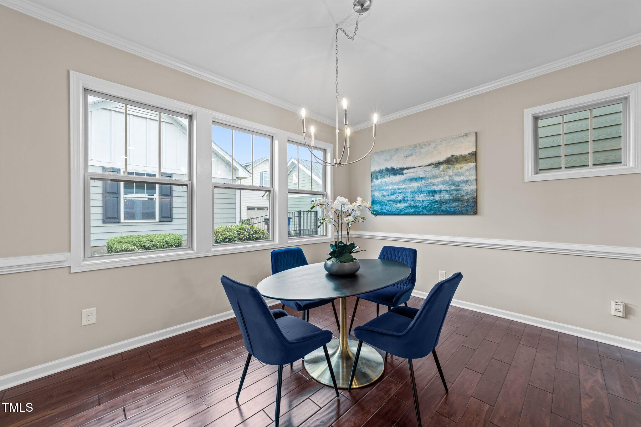 5644 Wade Park Boulevard Raleigh, NC 27607 - Photo 11 of 29 a view of a dining room with furniture large window and wooden floor