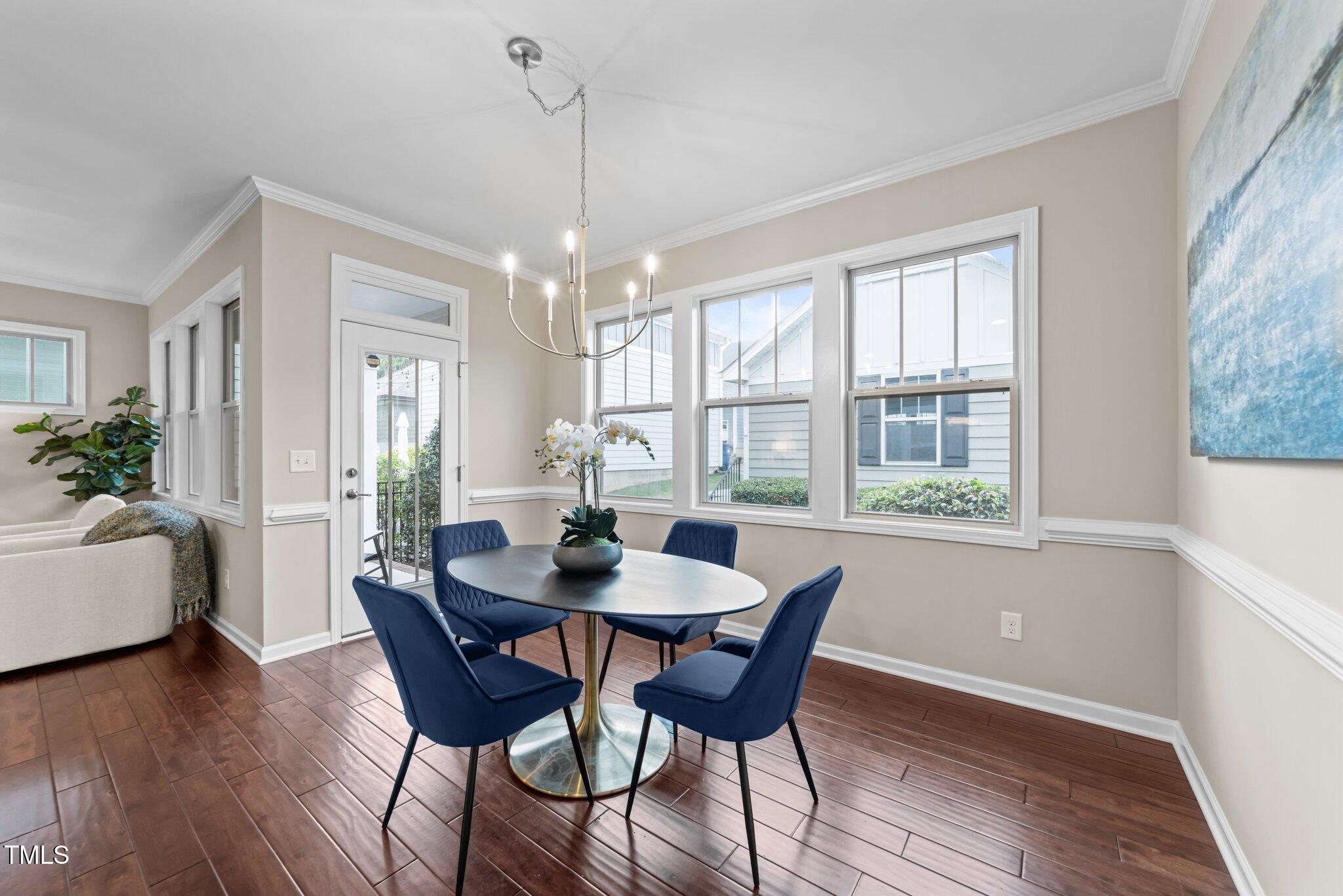 5644 Wade Park Boulevard Raleigh, NC 27607 - Photo 12 of 29 a view of a dining room with furniture window and wooden floor