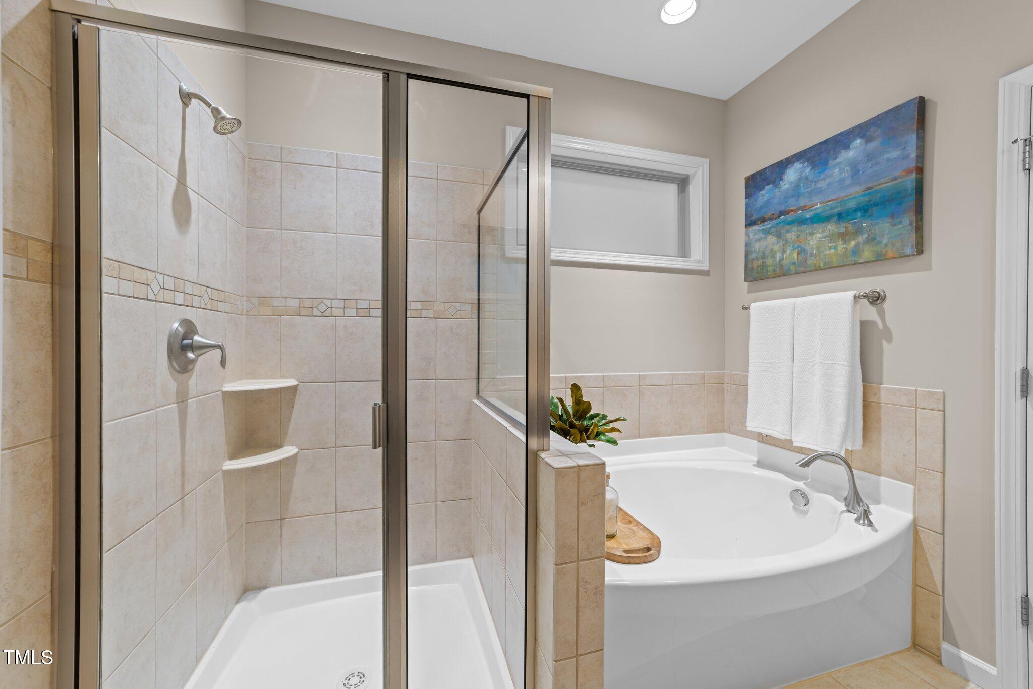 5644 Wade Park Boulevard Raleigh, NC 27607 - Photo 16 of 29 a bathroom with a tub and shower