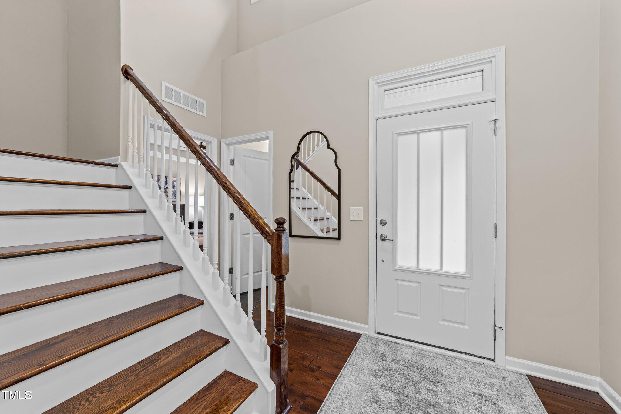 5644 Wade Park Boulevard Raleigh, NC 27607 - Photo 4 of 29 a view of staircase with wooden floor and a rug