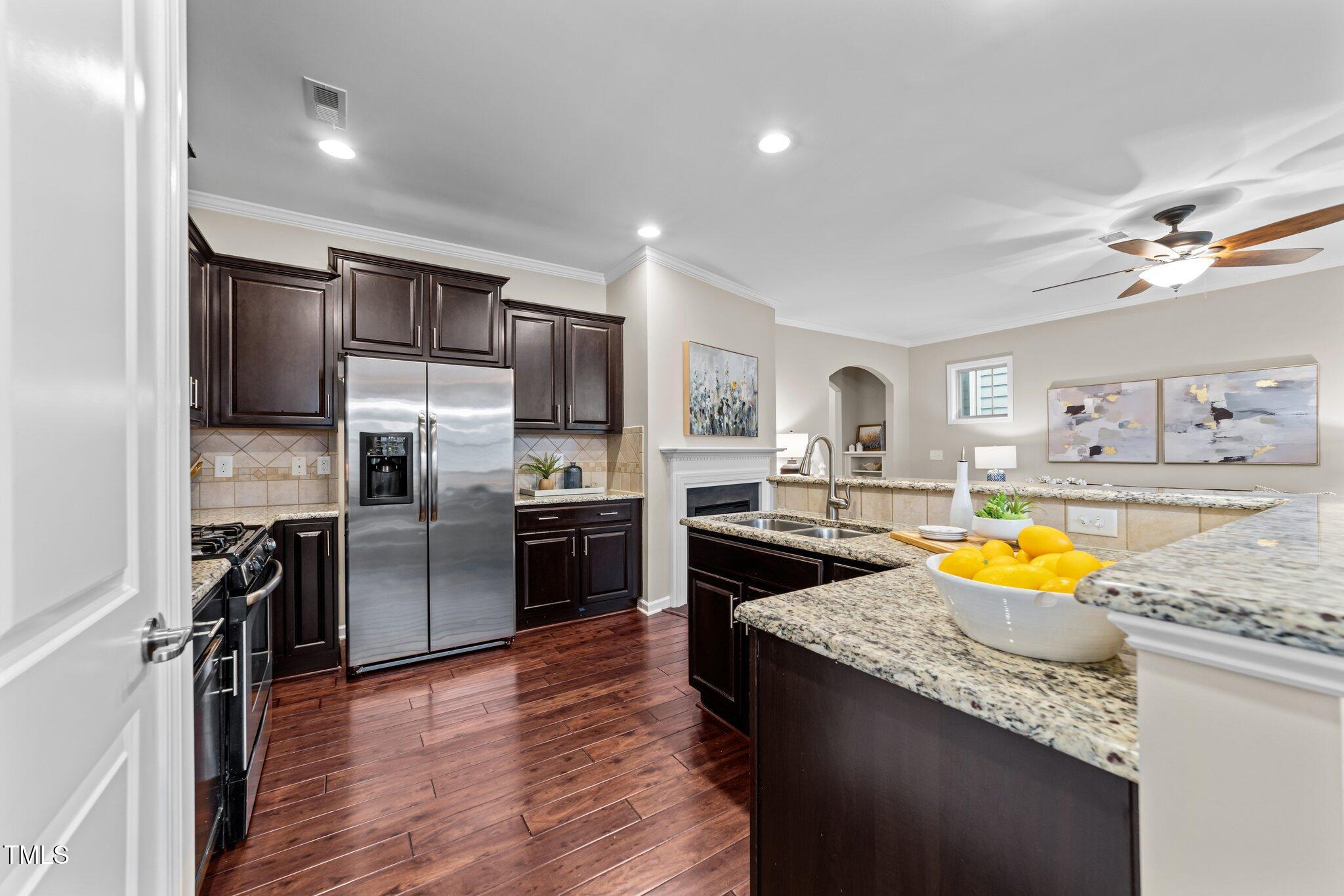 5644 Wade Park Boulevard Raleigh, NC 27607 - Photo 9 of 29 a kitchen with stainless steel appliances granite countertop a refrigerator a stove top oven a sink and dishwasher