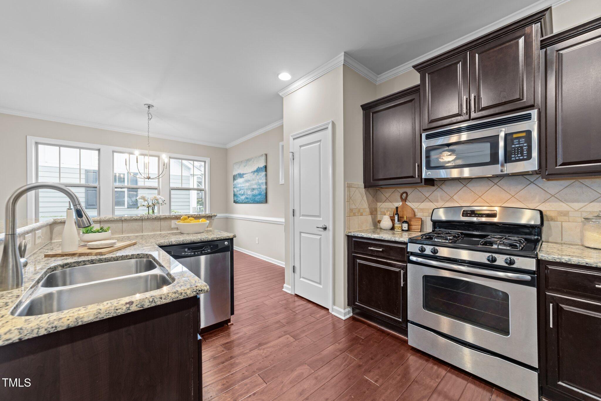 5644 Wade Park Boulevard Raleigh, NC 27607 - Photo 10 of 29 a kitchen with granite countertop a stove and a sink