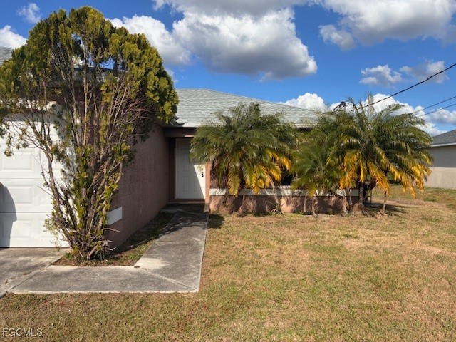 4522 20th Street Southwest Lehigh Acres, FL 33973 - Photo 2 of 9 a view of a yard with a tree