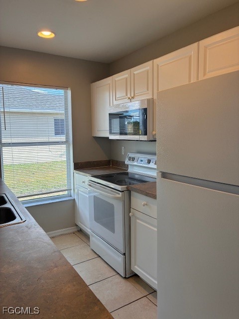 4522 20th Street Southwest Lehigh Acres, FL 33973 - Photo 8 of 9 a kitchen with stainless steel appliances granite countertop a sink and a stove