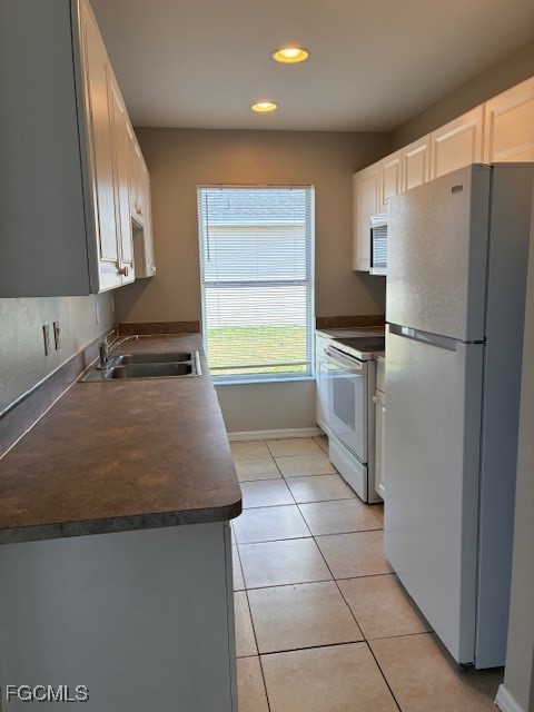 4522 20th Street Southwest Lehigh Acres, FL 33973 - Photo 9 of 9 a kitchen with a sink a stove a refrigerator and cabinets