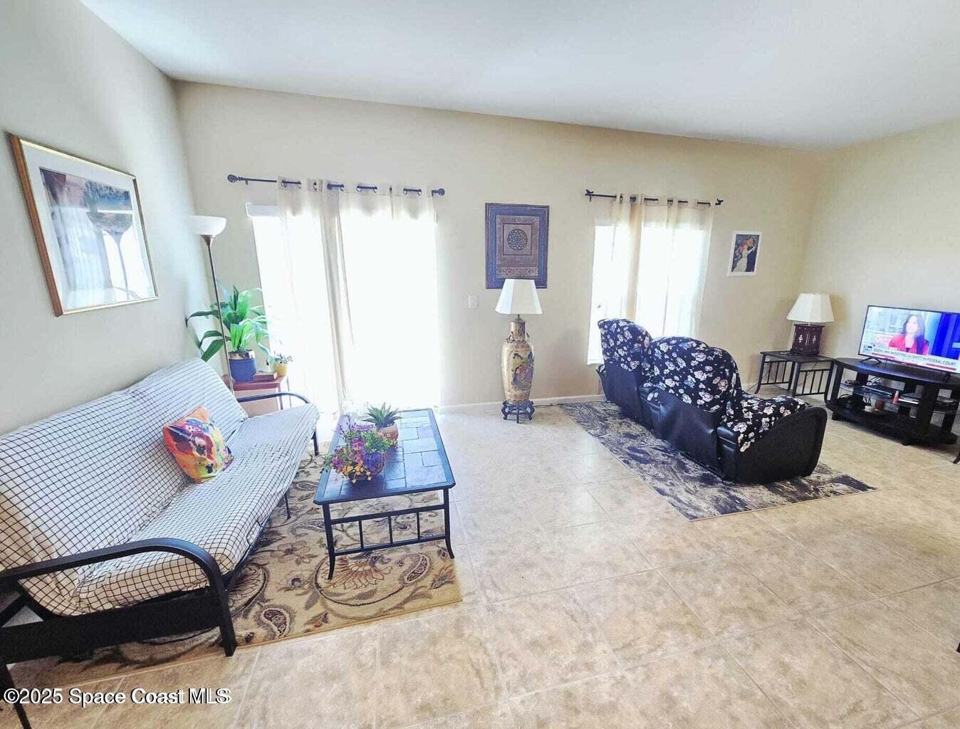2735 Revolution Street, Unit 101 Melbourne, FL 32935 - Photo 13 of 24 a living room with furniture and a couch
