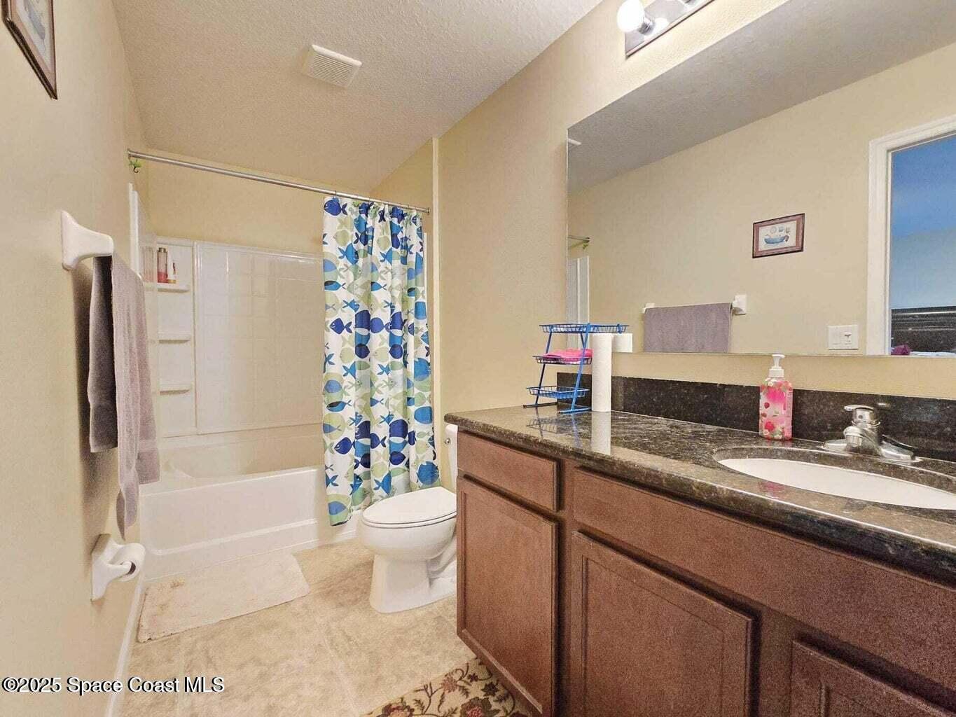 2735 Revolution Street, Unit 101 Melbourne, FL 32935 - Photo 15 of 24 a bathroom with a sink a toilet and shower