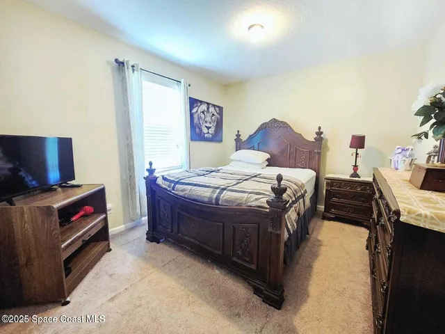 a bedroom with a bed and a tv