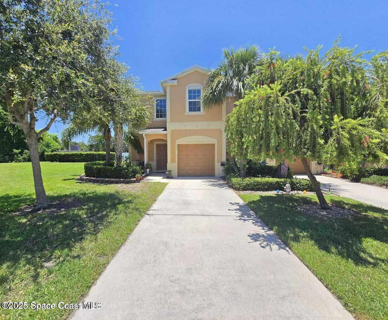 2735 Revolution Street, Unit 101 Melbourne, FL 32935 - Photo 2 of 24 front view of a house with a yard
