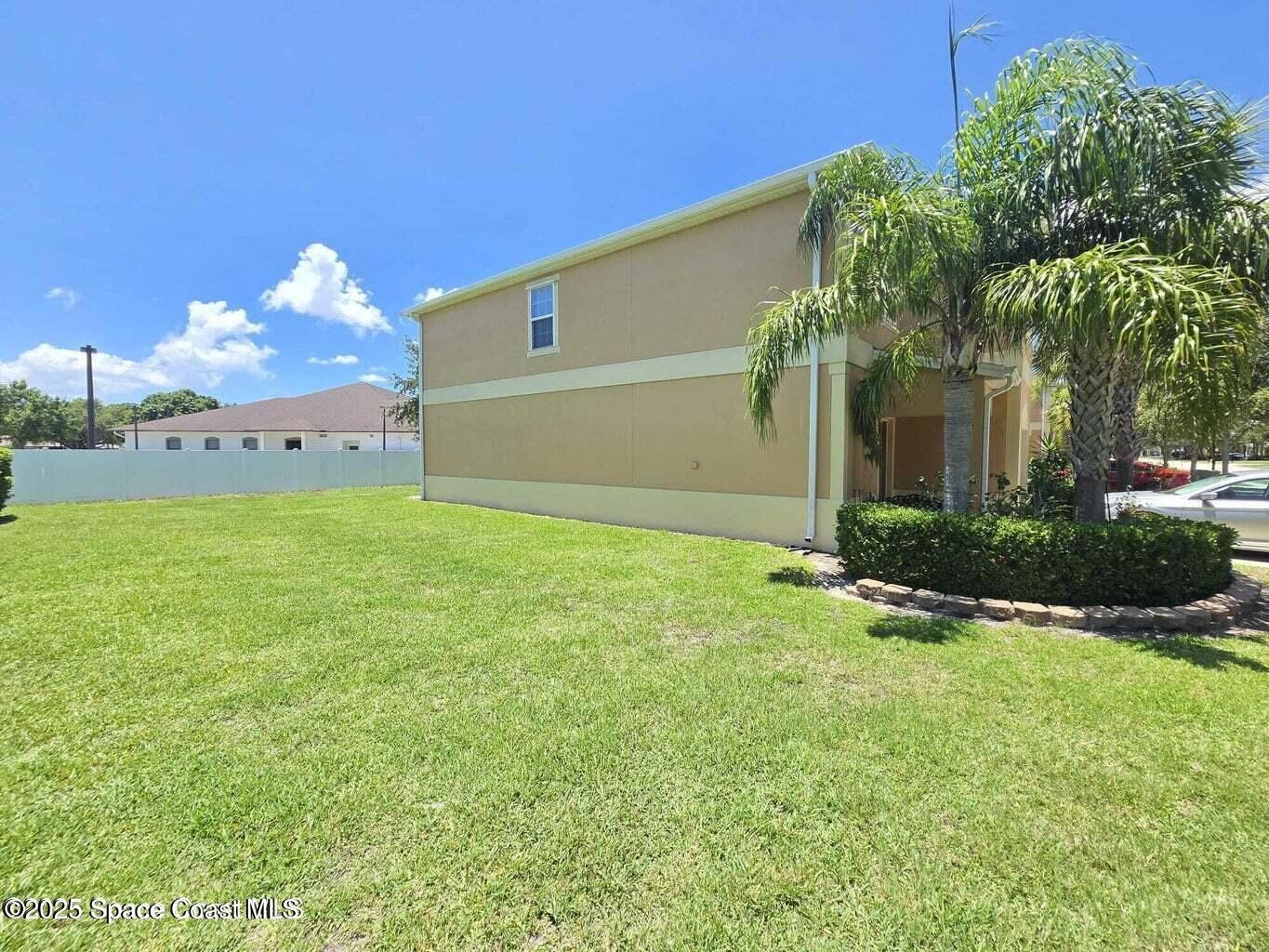 2735 Revolution Street, Unit 101 Melbourne, FL 32935 - Photo 3 of 24 a front view of a house with garden