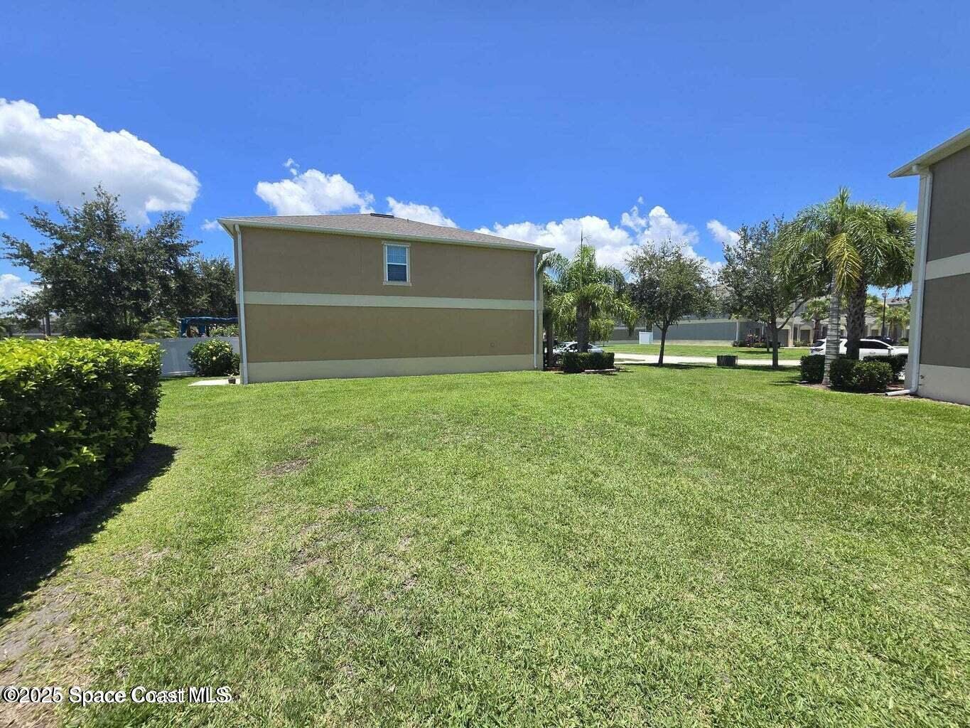 2735 Revolution Street, Unit 101 Melbourne, FL 32935 - Photo 5 of 24 a view of a house with a yard