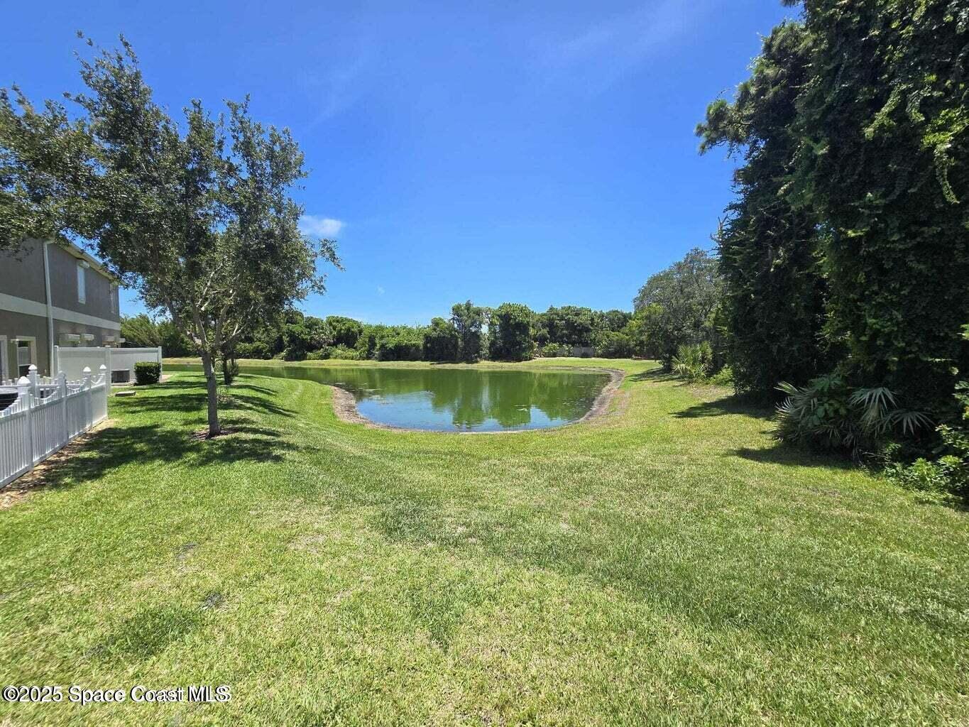 2735 Revolution Street, Unit 101 Melbourne, FL 32935 - Photo 6 of 24 a view of a lake with a yard