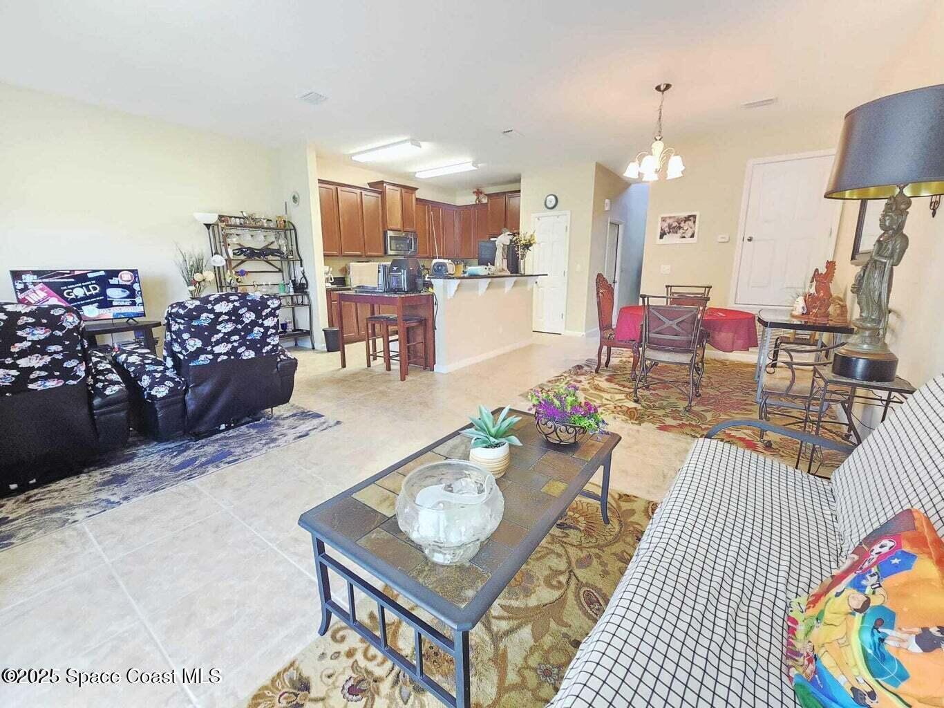 2735 Revolution Street, Unit 101 Melbourne, FL 32935 - Photo 10 of 24 a living room with furniture and a table