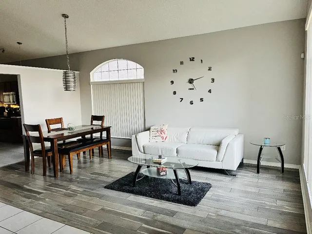 a living room with furniture and a chandelier