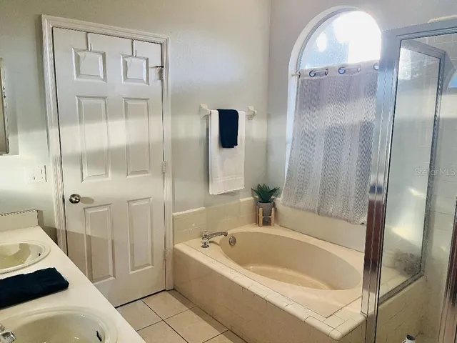 a bathroom with a tub and shower