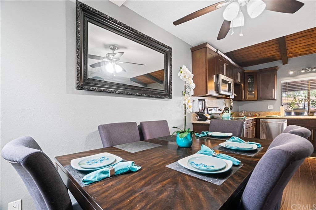 1040 West MacArthur Boulevard, Unit 104 Santa Ana, CA 92707 - Photo 12 of 30 a living room with furniture and a dining table with kitchen view