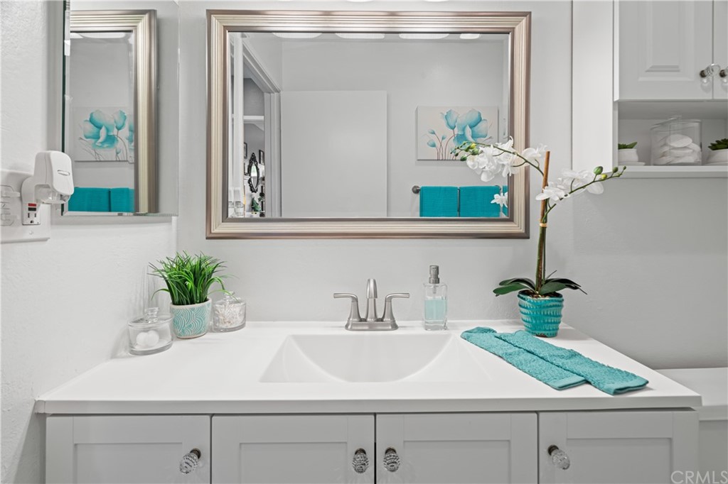 1040 West MacArthur Boulevard, Unit 104 Santa Ana, CA 92707 - Photo 15 of 30 a bathroom with a sink and a mirror
