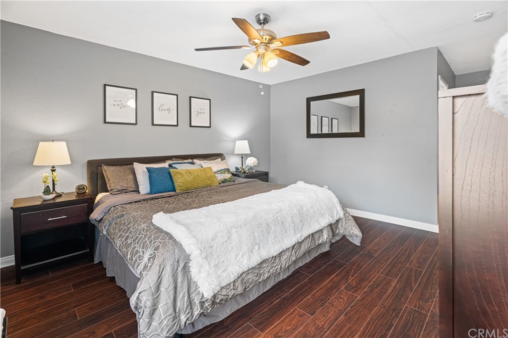 1040 West MacArthur Boulevard, Unit 104 Santa Ana, CA 92707 - Photo 20 of 30 a bedroom with bed and wooden floor