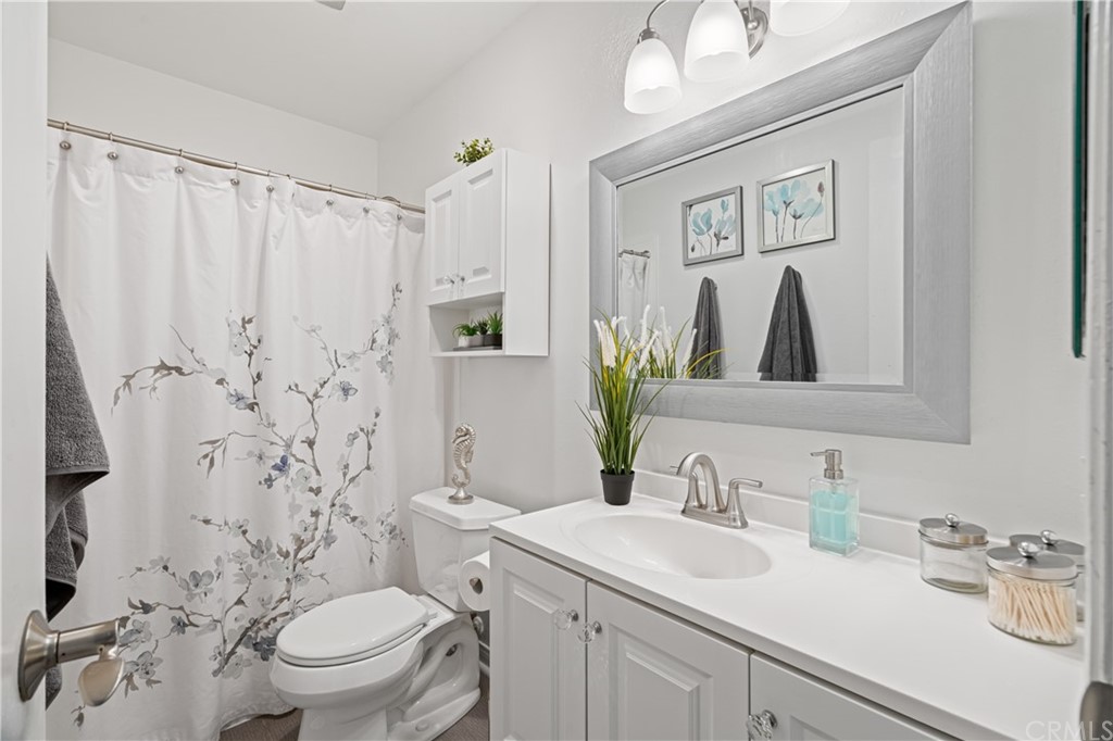 1040 West MacArthur Boulevard, Unit 104 Santa Ana, CA 92707 - Photo 21 of 30 a bathroom with a sink toilet and shower