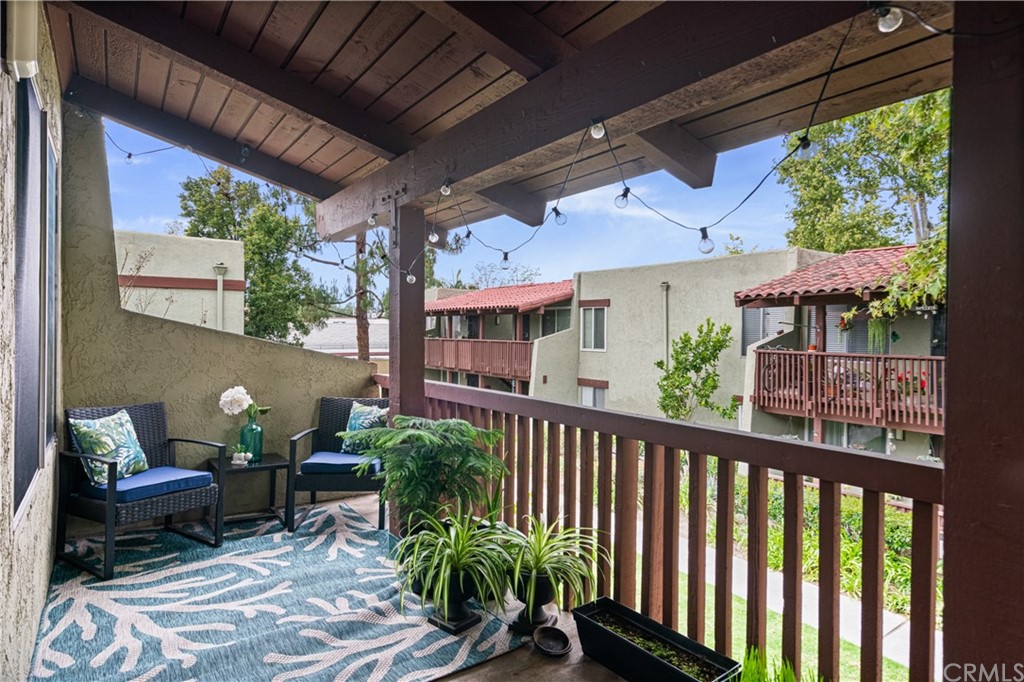 1040 West MacArthur Boulevard, Unit 104 Santa Ana, CA 92707 - Photo 25 of 30 a view of a patio with table and chairs potted plants with floor to ceiling window