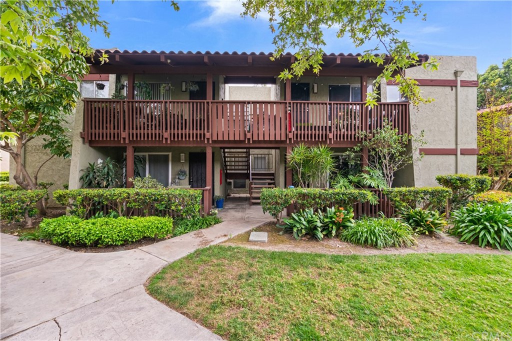 1040 West MacArthur Boulevard, Unit 104 Santa Ana, CA 92707 - Photo 27 of 30 a front view of a house with a garden