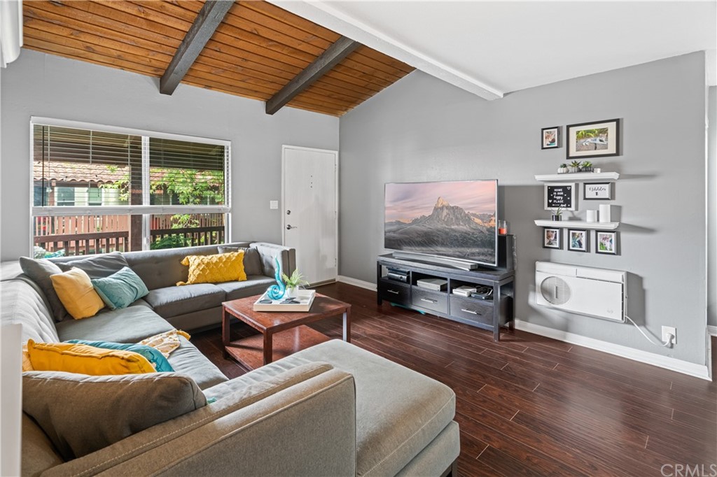1040 West MacArthur Boulevard, Unit 104 Santa Ana, CA 92707 - Photo 4 of 30 a living room with furniture and a flat screen tv
