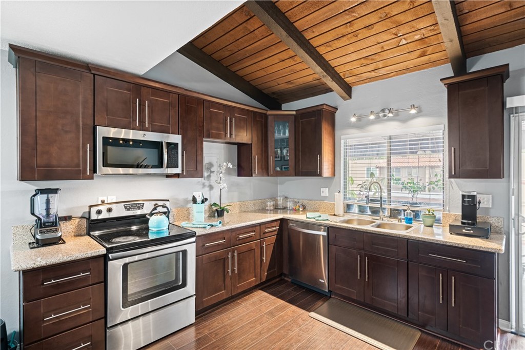 1040 West MacArthur Boulevard, Unit 104 Santa Ana, CA 92707 - Photo 8 of 30 a kitchen with a sink stove and microwave