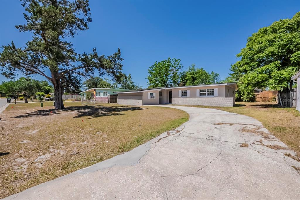 3718 Mitchell Road Orlando, FL 32808 - Photo 1 of 1 a view of street with large trees
