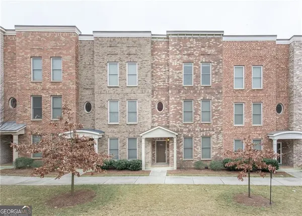 a front view of a brick building with large windows