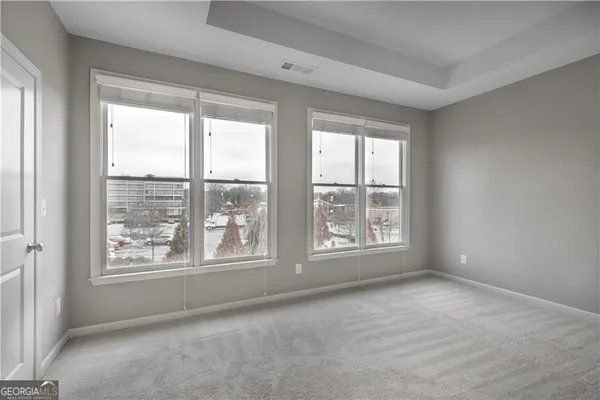 a view of an empty room with a window