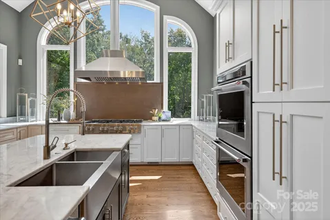 a kitchen with a sink and a stove top oven