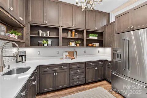 a kitchen with stainless steel appliances granite countertop a refrigerator and a sink