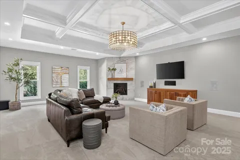 a living room with fireplace furniture and a flat screen tv