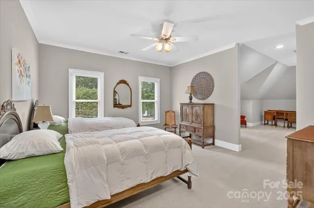 a bedroom with a bed large window and couch