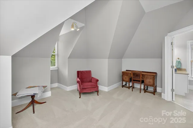 a living room with furniture and a chair