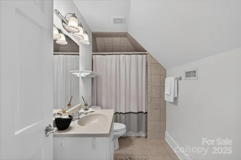 a bathroom with a sink and mirror with toilet