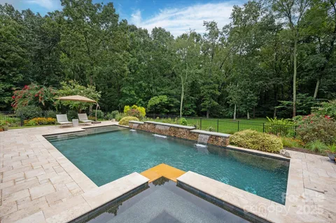 a view of a garden with lawn chairs