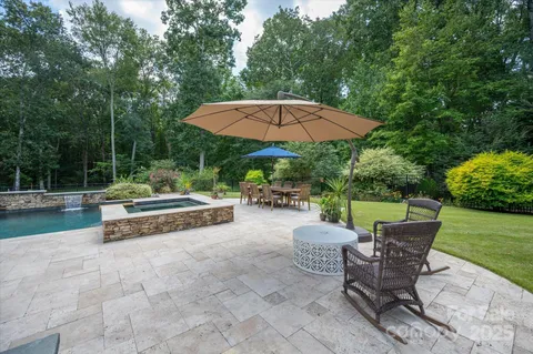 a view of a patio with a table and chairs under an umbrella