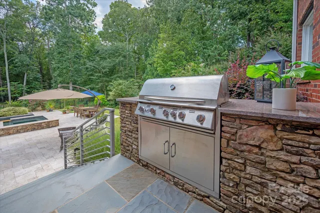 a view of a backyard with a patio and fire pit